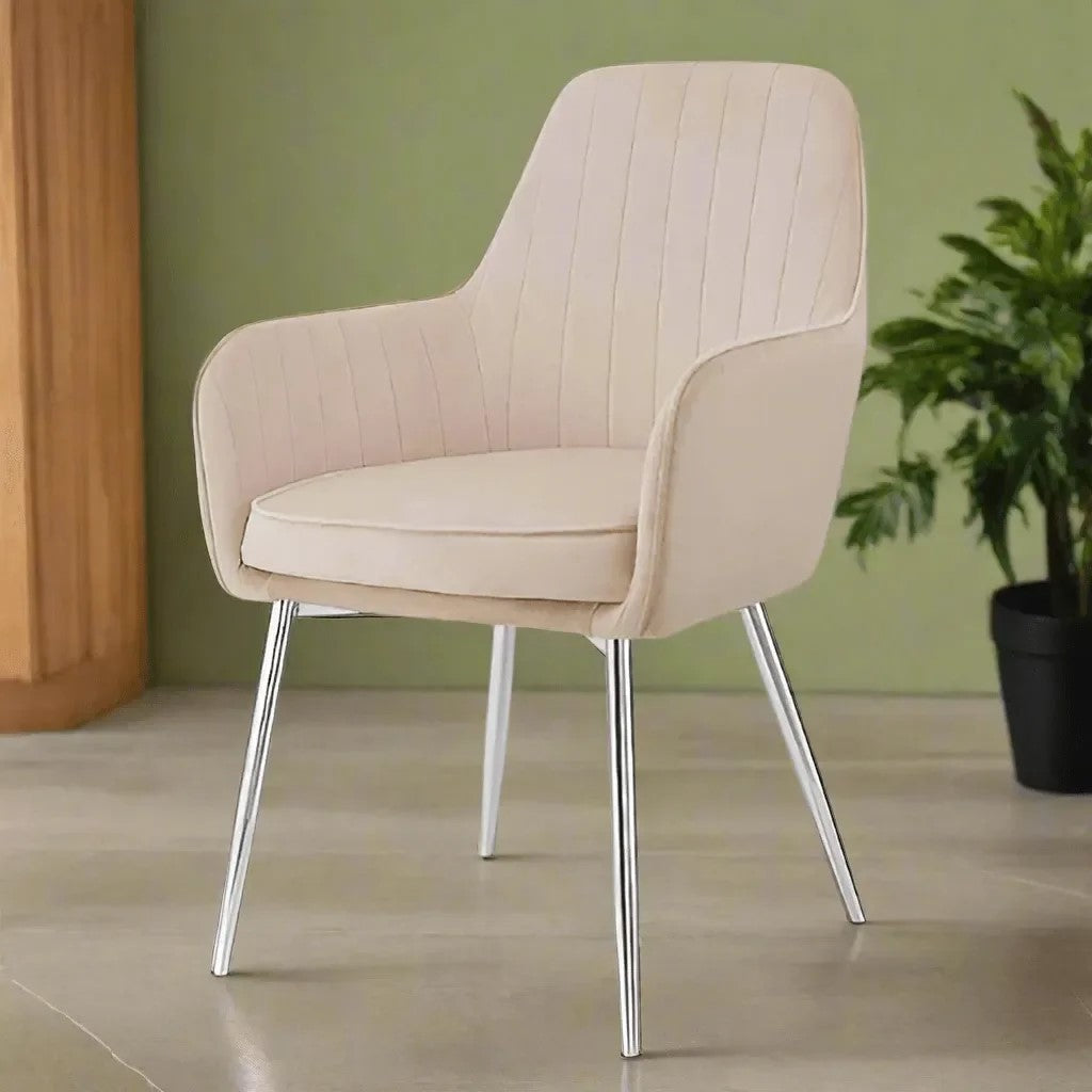 Beige upholstered armchair with cushioned seat, curved backrest, and chrome metal legs in a modern interior setting.