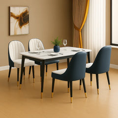 Dining room with a table set for four, featuring chairs with gold legs.