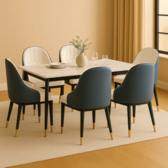 Dining room setup with a marble table and modern chairs in a well-lit room.