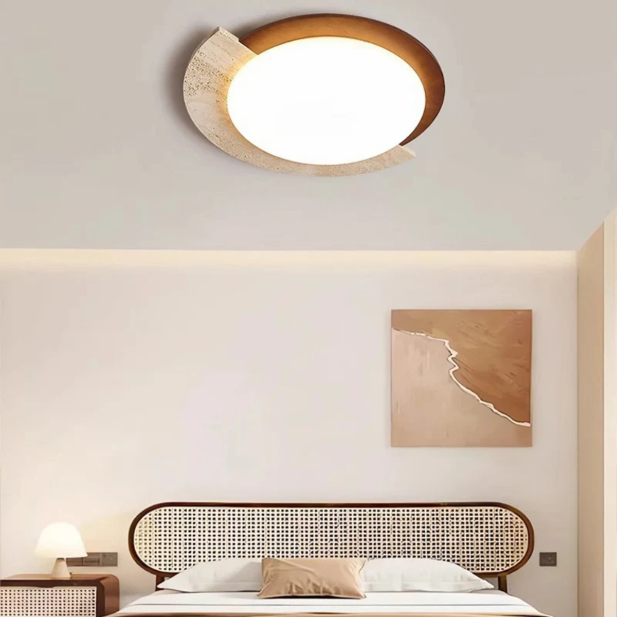 Heritage Glow Travertine LED Ceiling Light installed above a bedroom with rattan headboard and wall art