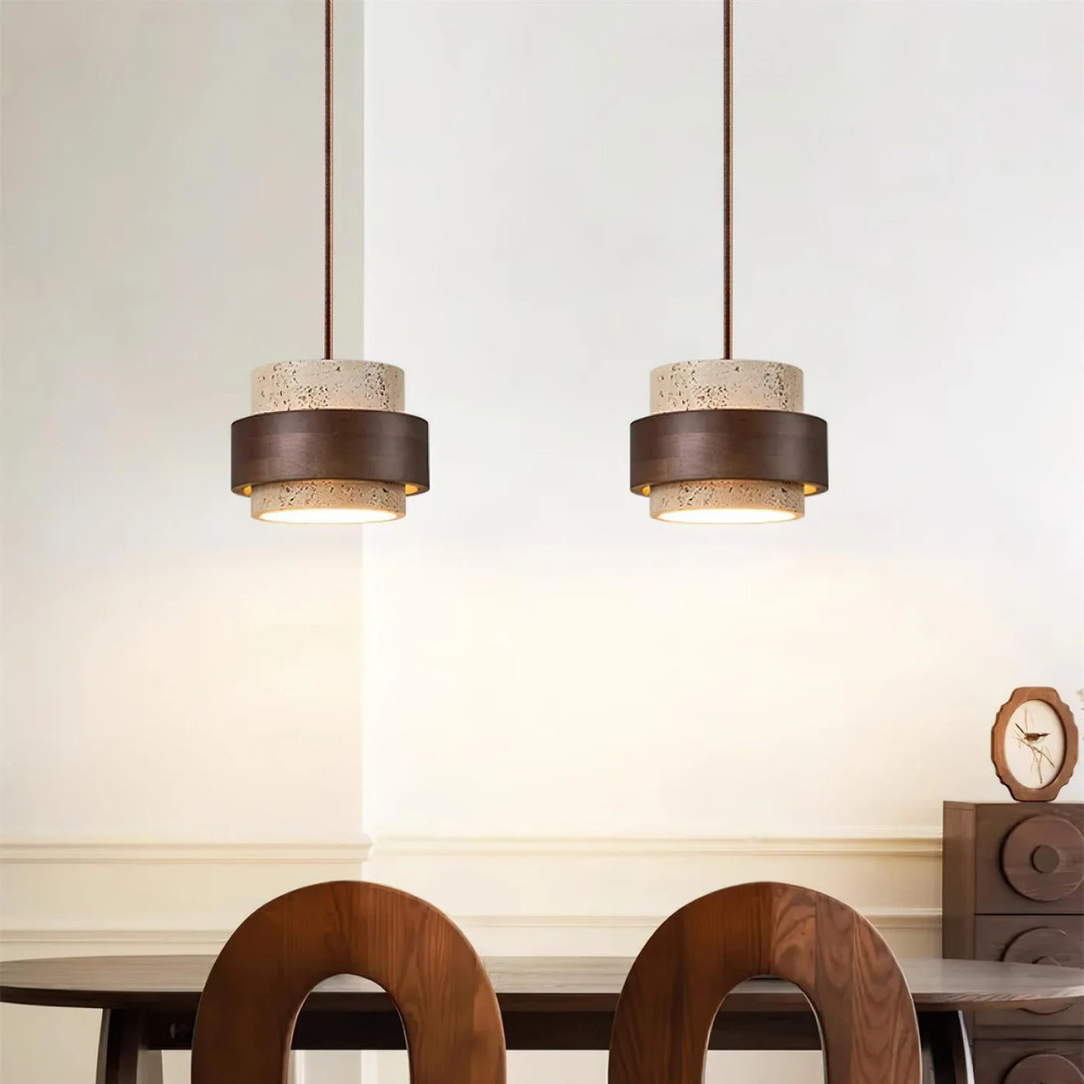 two TerraHalo pendants side by side above a dining table with wood chairs