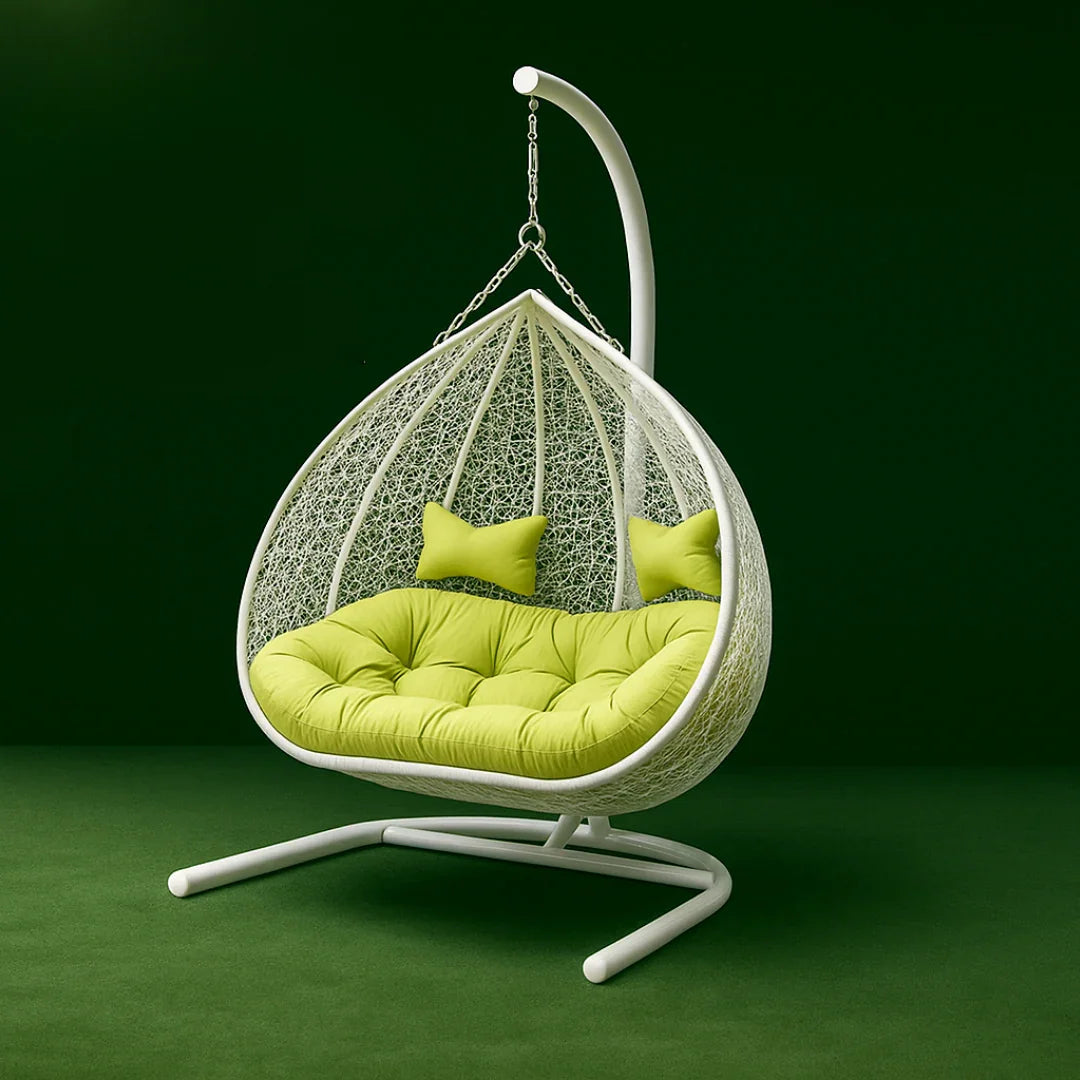 Hanging chair with green cushions on a dark green background