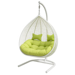 White hanging egg chair with green cushions on a white background