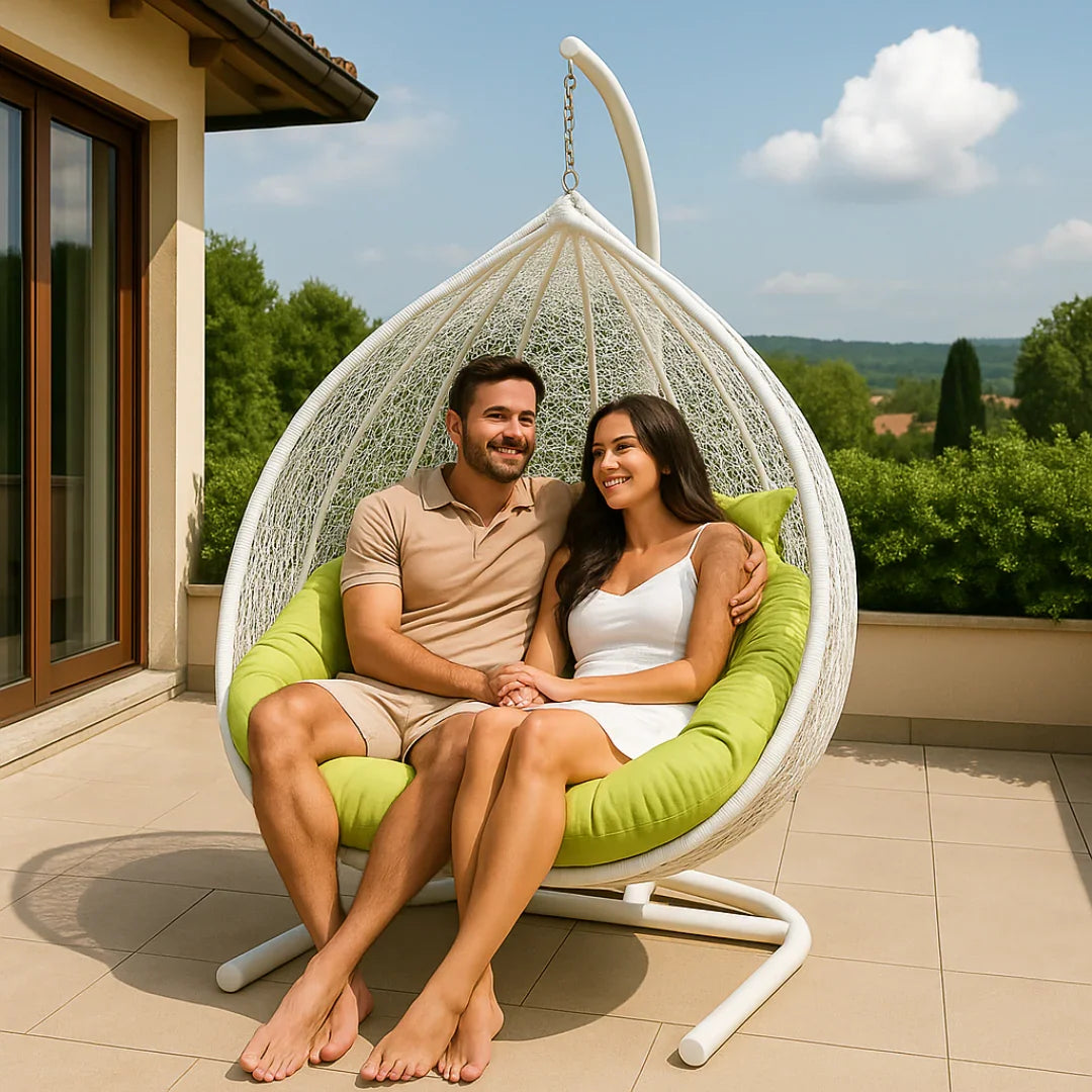 Couple sitting in a modern hanging chair on a sunny day.