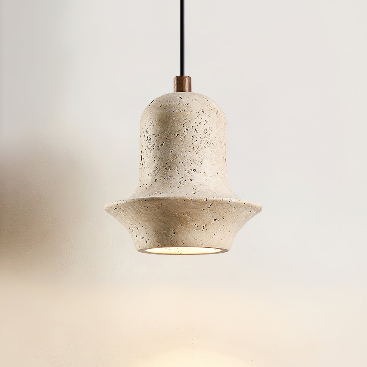 Bellora Sculpted Travertine Pendant Light - close-up straight-on view, lit