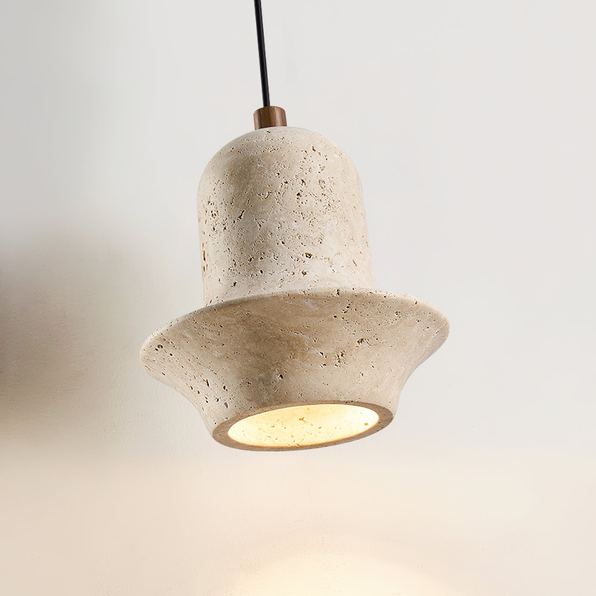 Bellora Sculpted Travertine Pendant Light - close-up detail view, lit