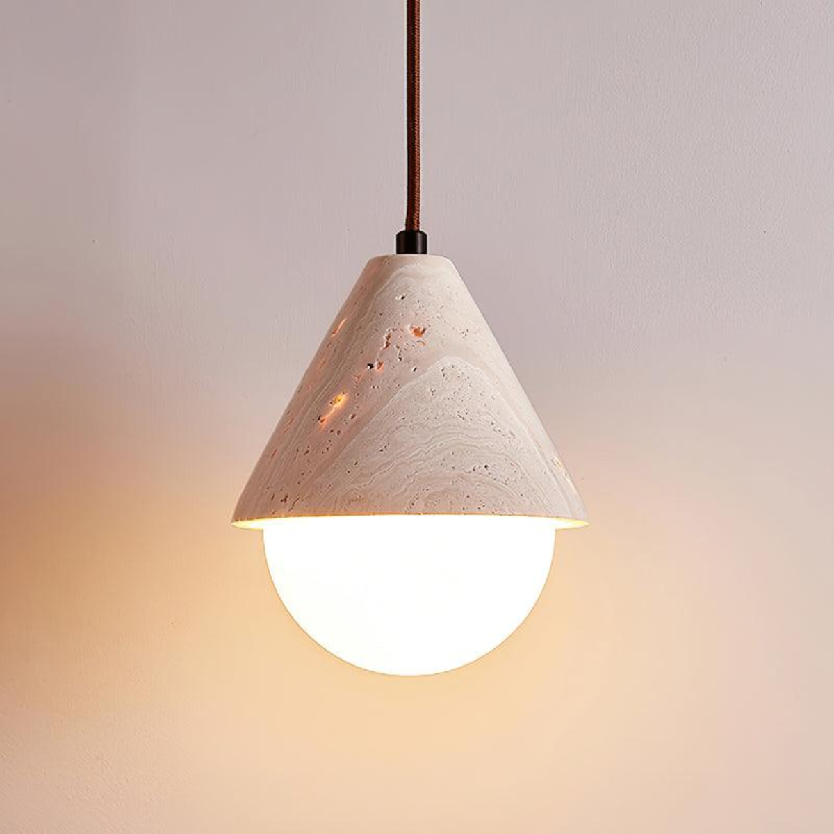 front view of Travessa pendant lit, gray background