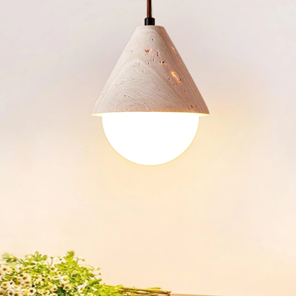 lifestyle above a side table with a clear vase near daisies