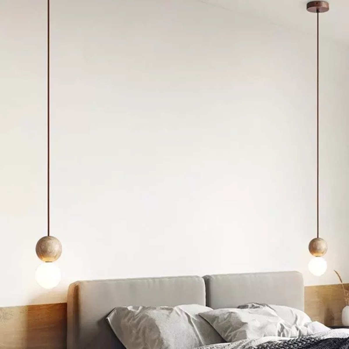 Mia Orb Pendant Light Natural - lifestyle above a bed with grey upholstered headboard