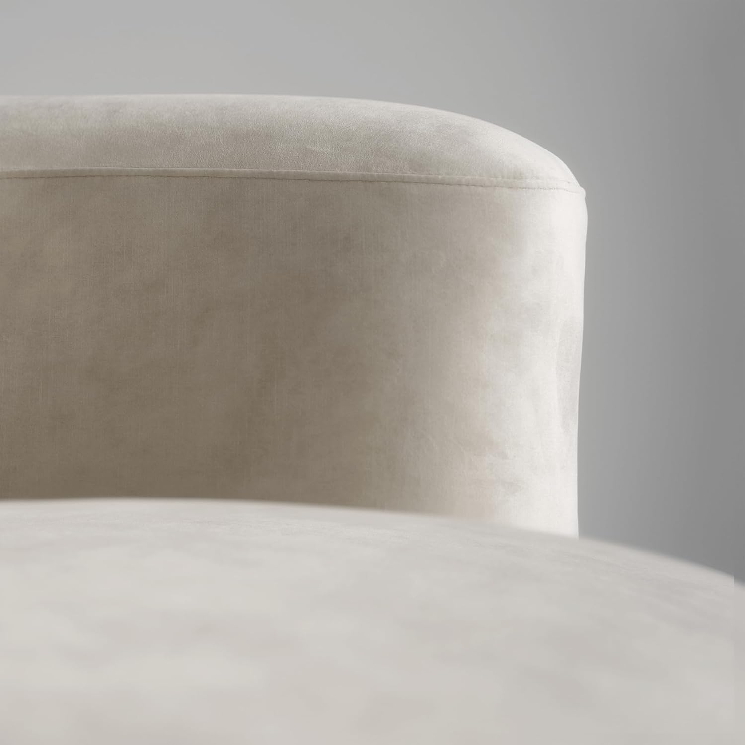 Close-up of a beige upholstered chair with a plain background