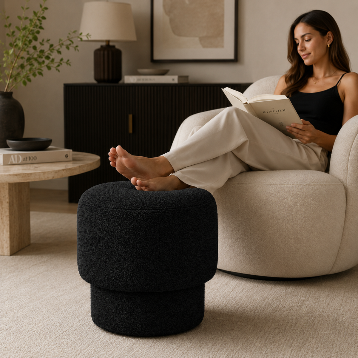 Person resting feet on Wooden Twist Mushroom Bouclé Ottoman Stool in Black – lifestyle with model