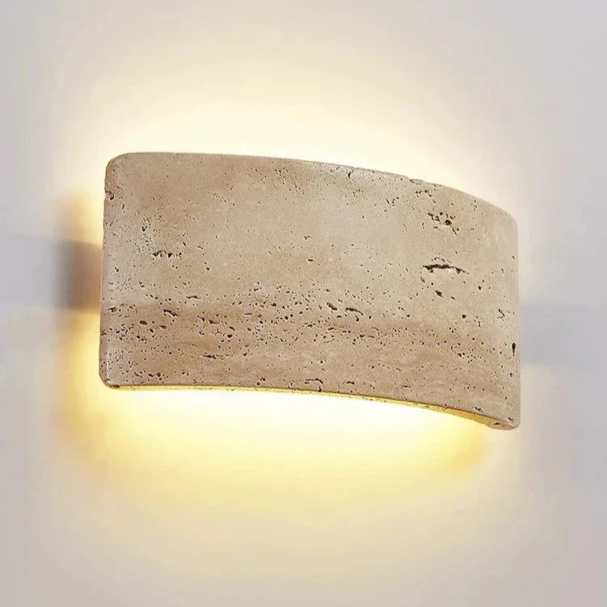 Arclume Yellow Travertine Wall Light mounted on a wall with warm up and down LED glow