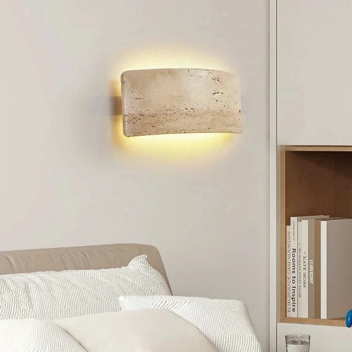 Arclume Yellow Travertine Wall Light installed above a bedside bookshelf in a bedroom