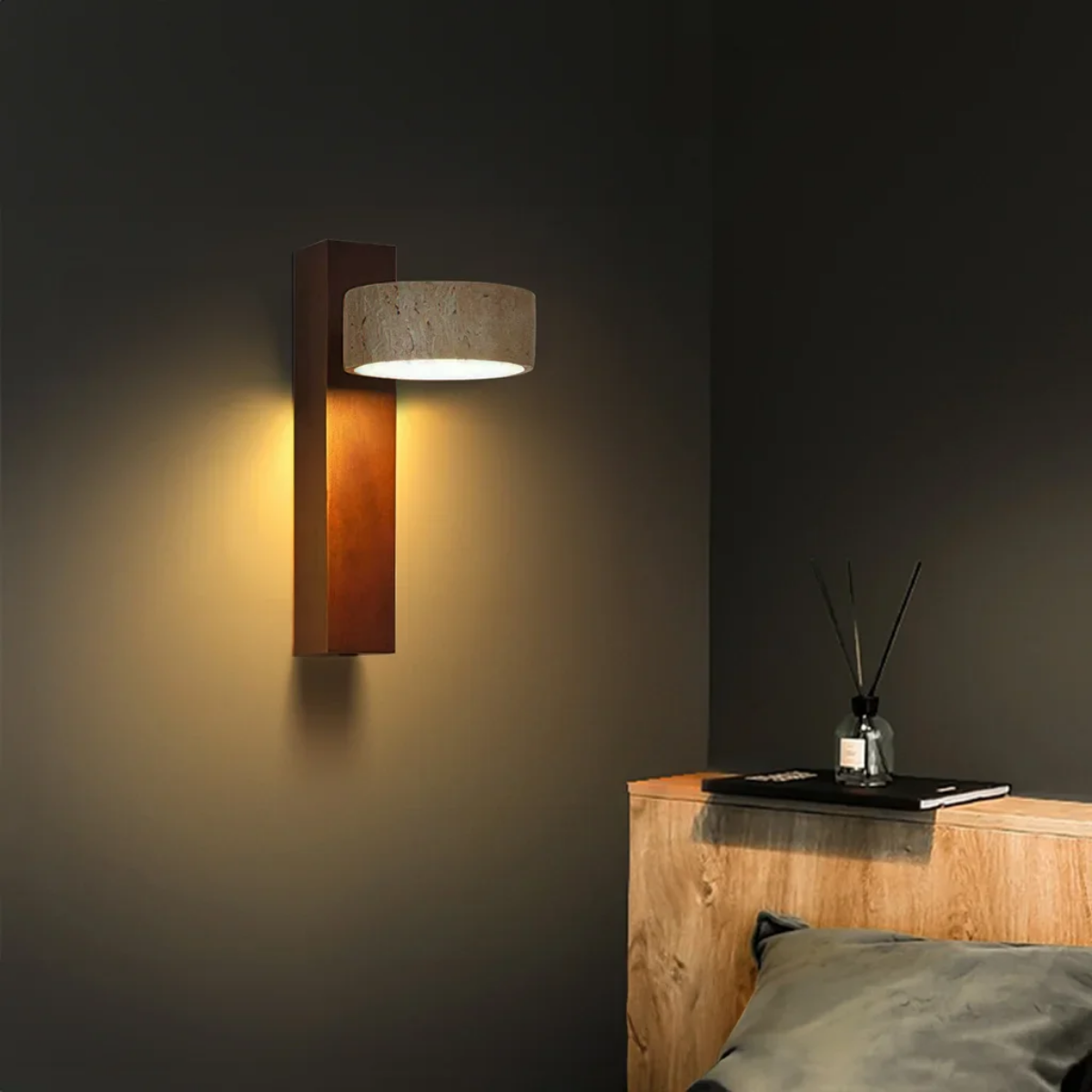 Aurevo Travertine Rotatable Wall Lamp lit at night above a rattan headboard bed