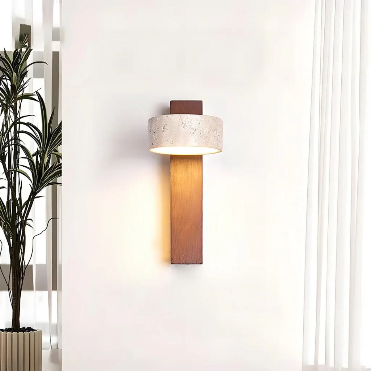 Aurevo Travertine Rotatable Wall Lamp lifestyle view beside a curtain and tall potted plant