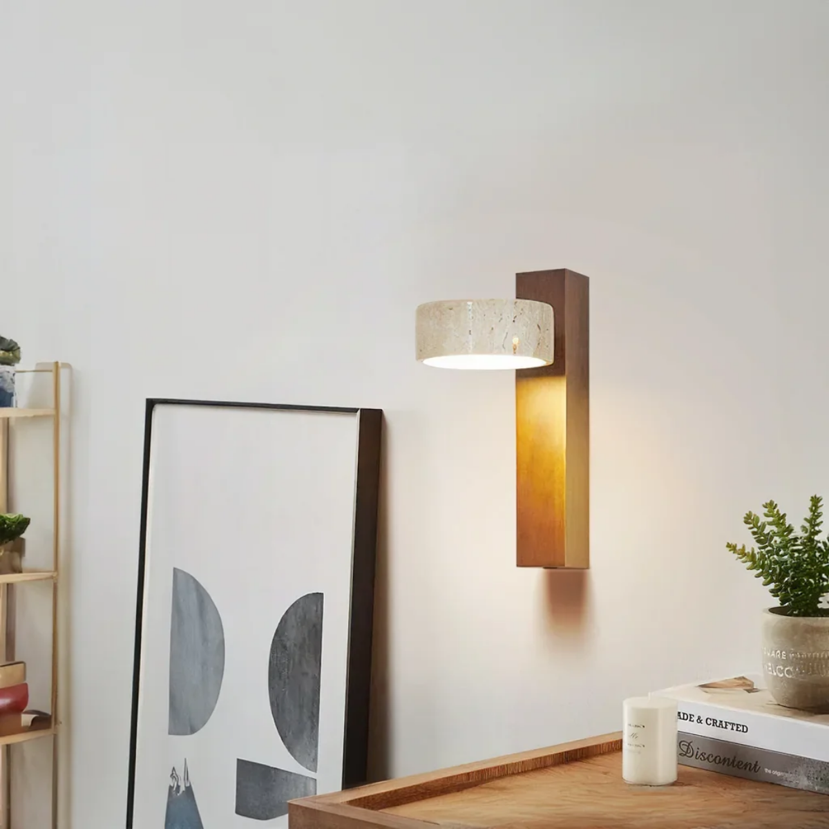 Aurevo Travertine Rotatable Wall Lamp in a styled living room with framed art, bookshelf, and plant