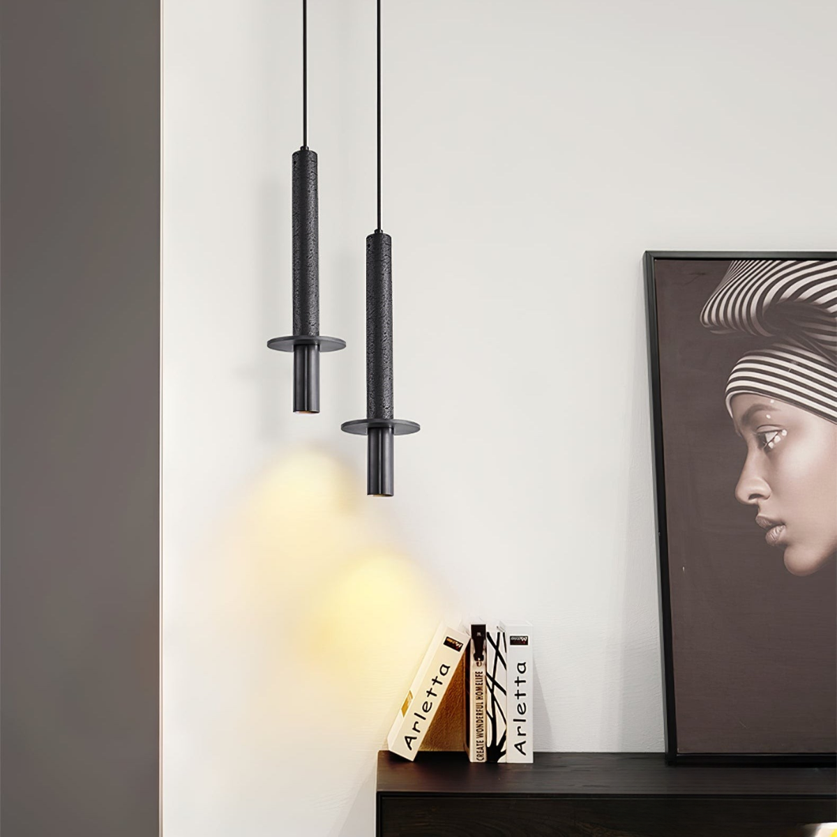 Aurevia Pendant Light Black Travertine + Black - lifestyle beside a dark console with framed art