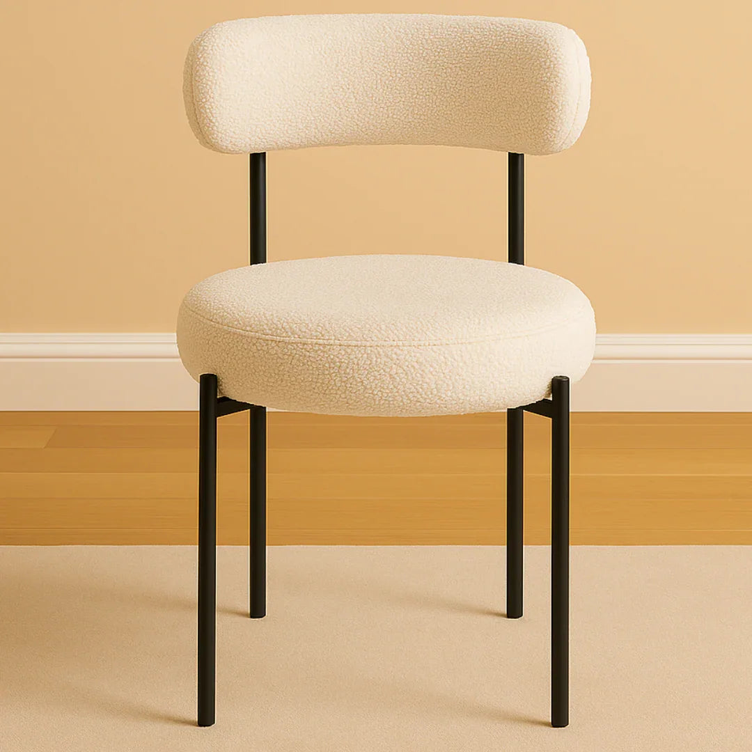 Beige chair with black legs on a beige floor and wall