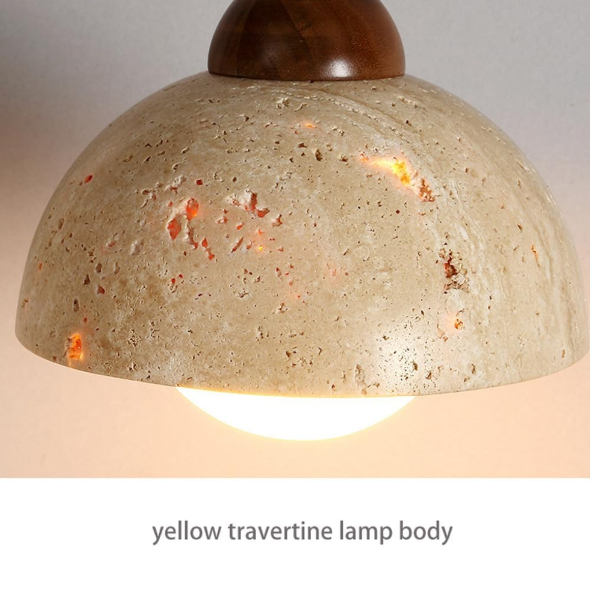 Close-up of the yellow travertine lamp body glowing warm light on Aurelia Dome Pendant Light