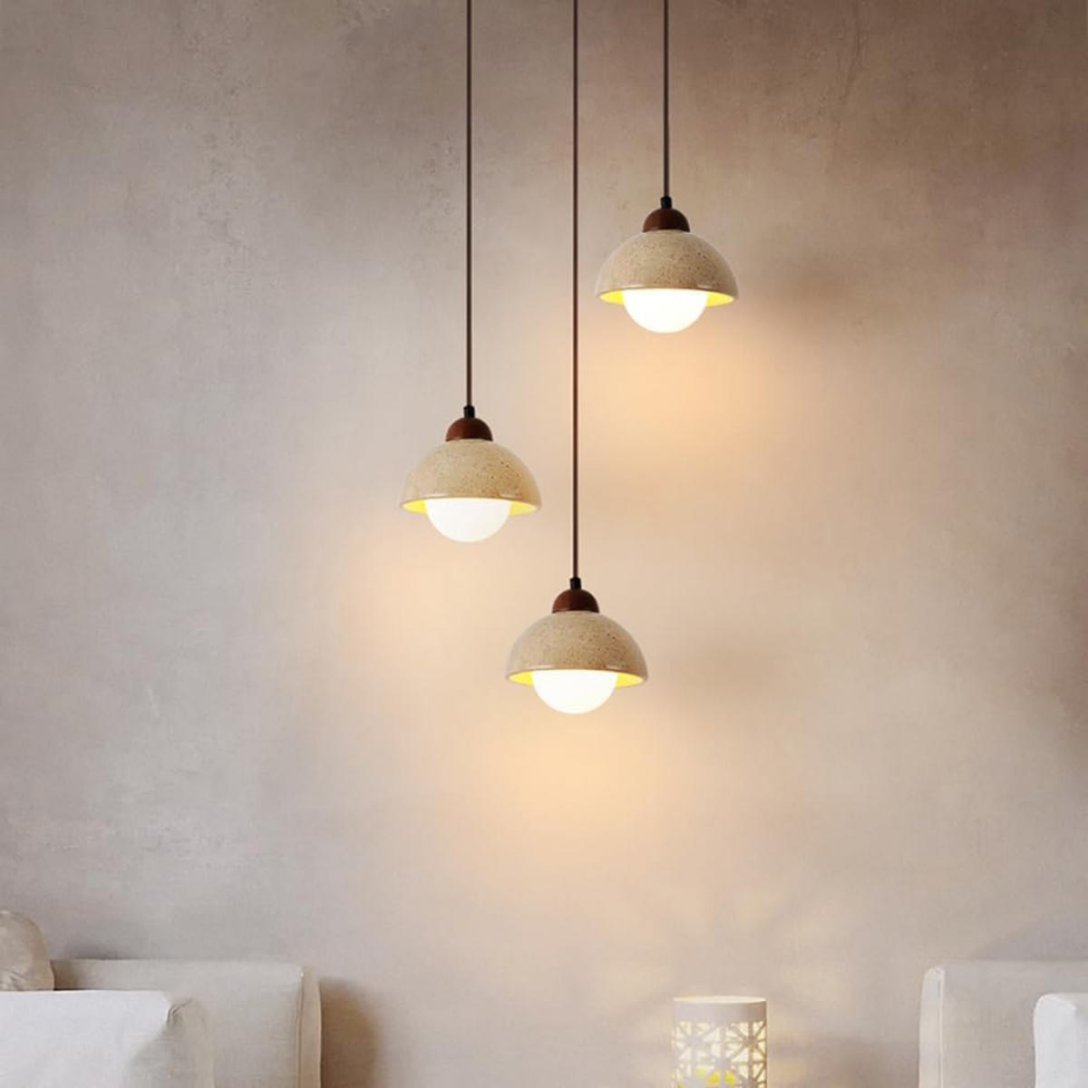 Three Aurelia Travertine Dome Pendant Lights cascading above a living room seating area