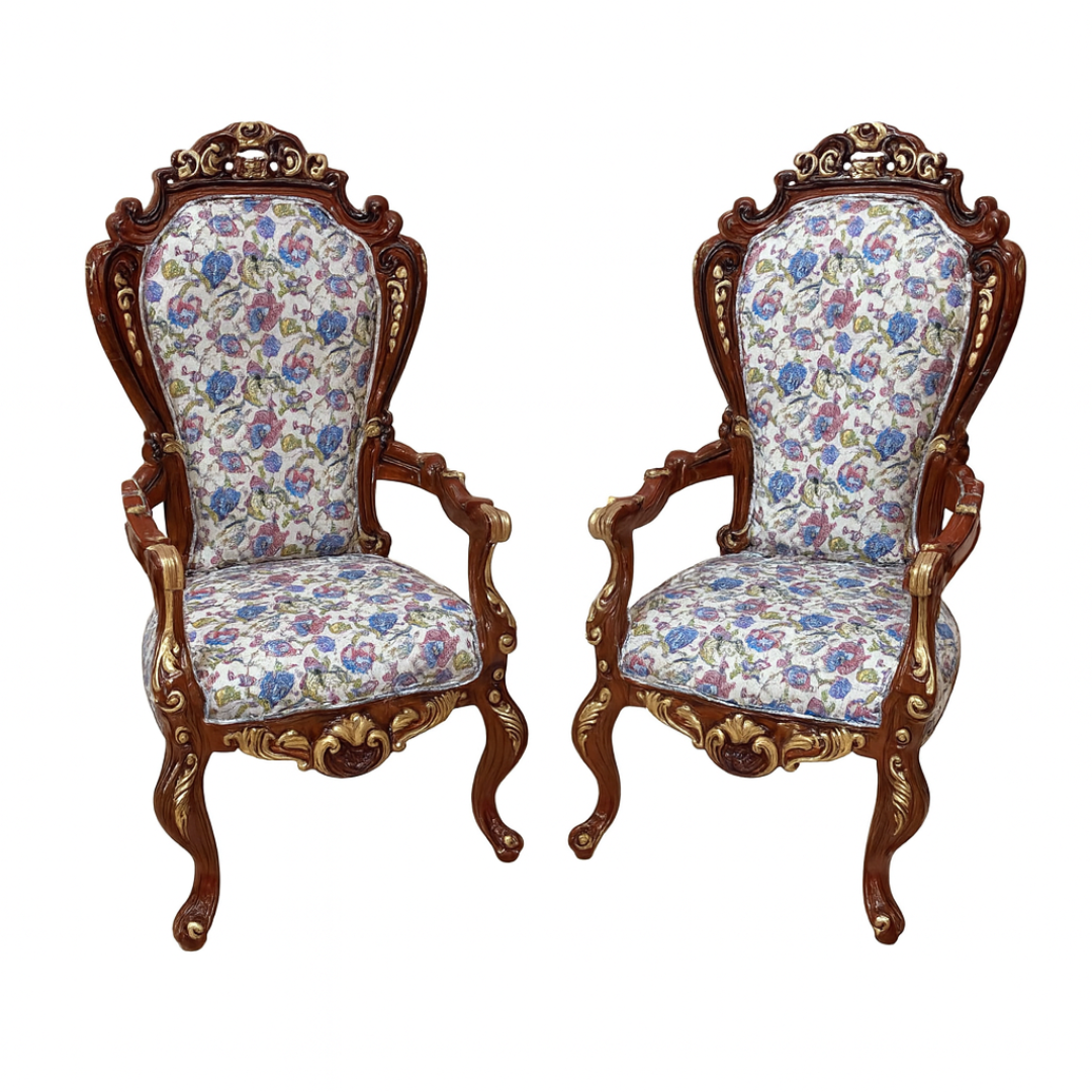 Pair of ornate chairs with floral upholstery on a white background