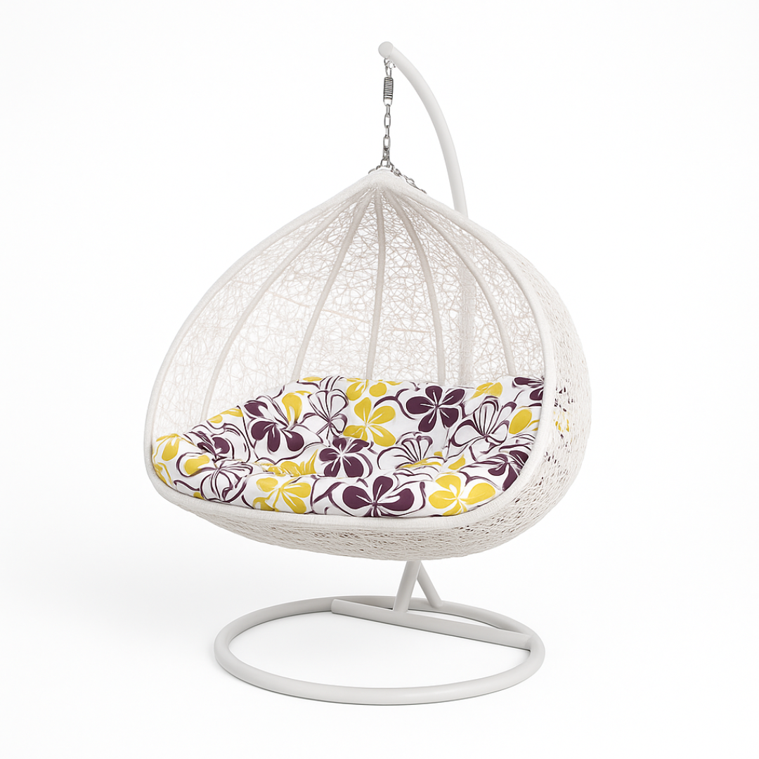 White wicker egg chair with a floral cushion on a white background