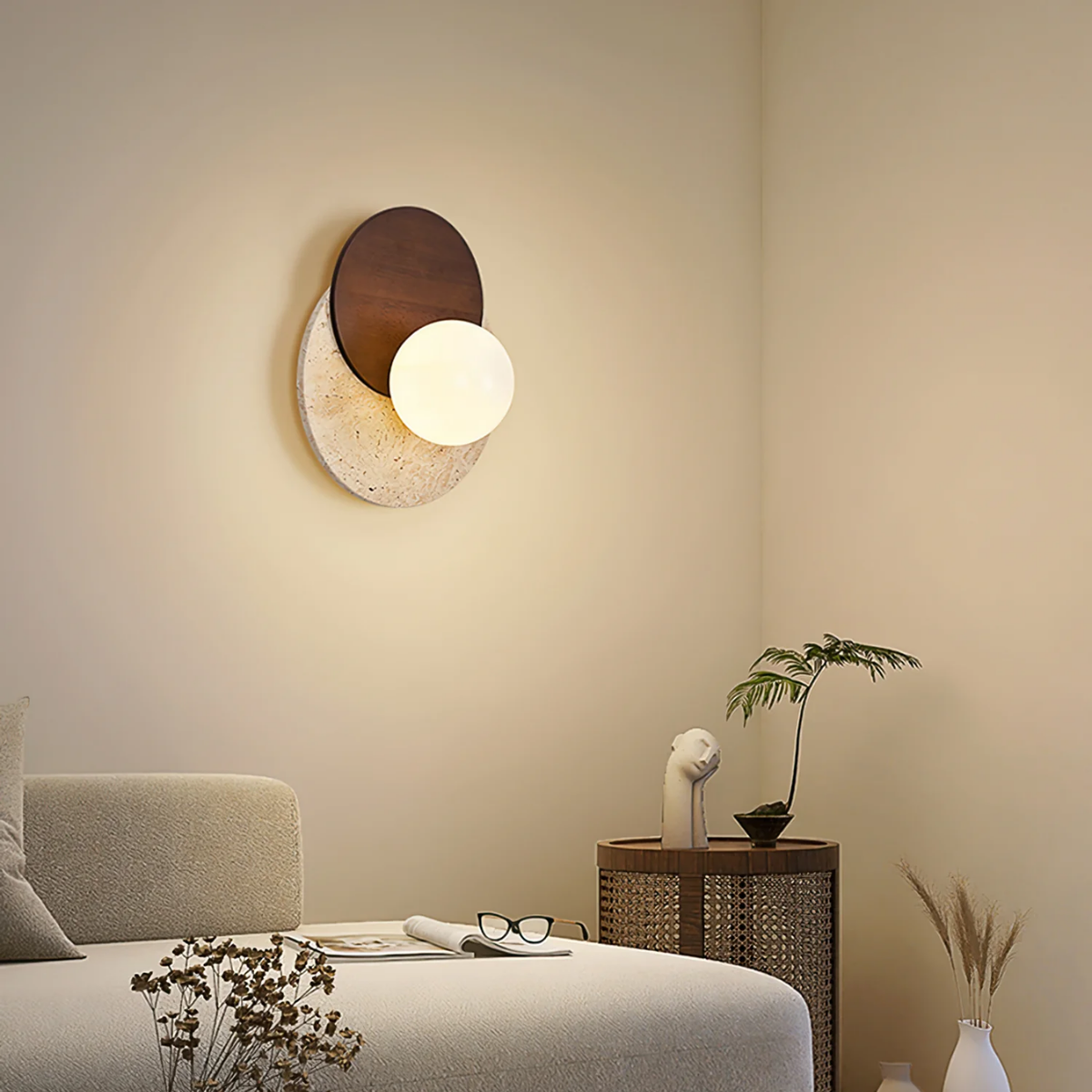 Lunara Travertine Stone & Wood Lunar Eclipse Wall Light installed in a bedroom corner beside a side table