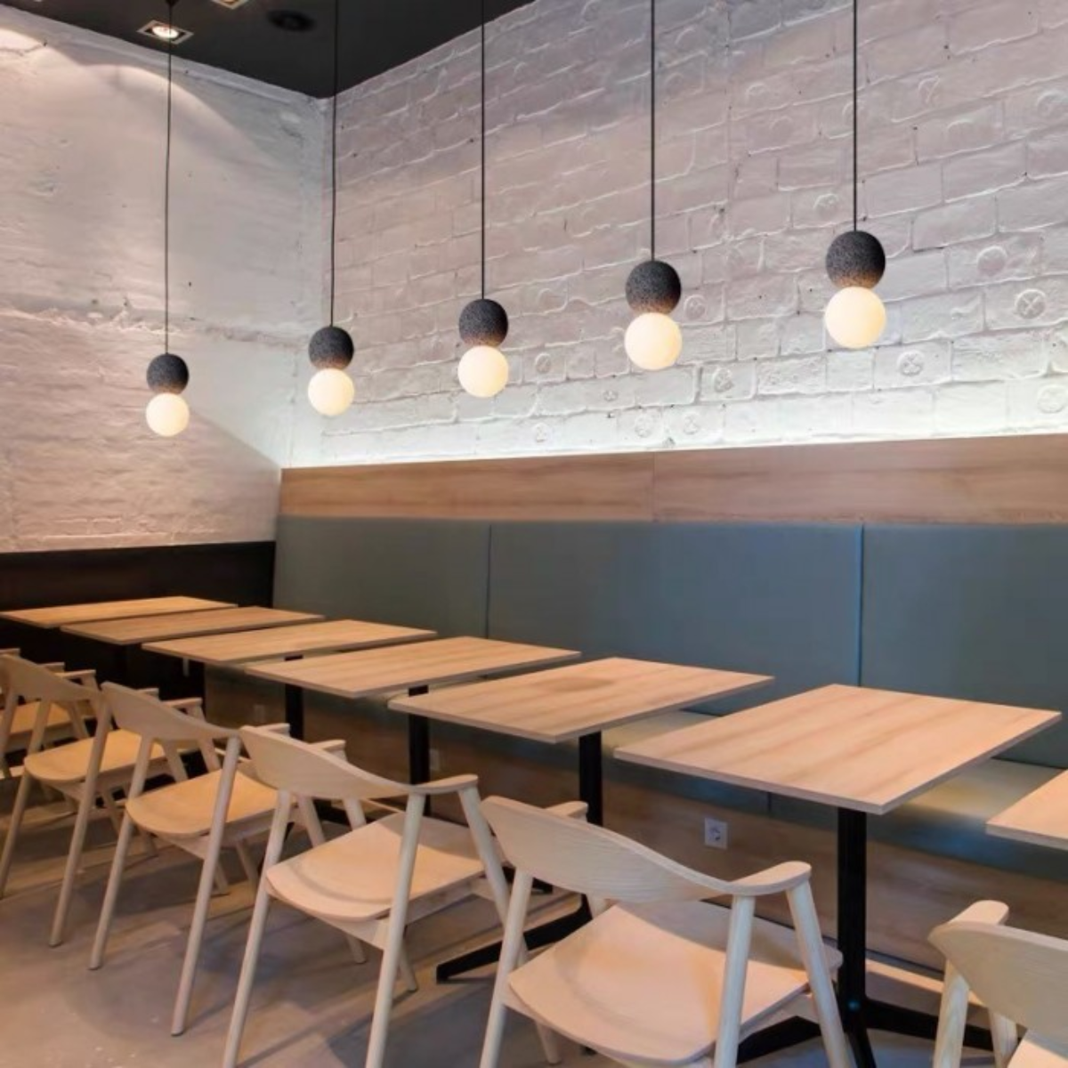 lifestyle five pendants in a row above cafe dining tables