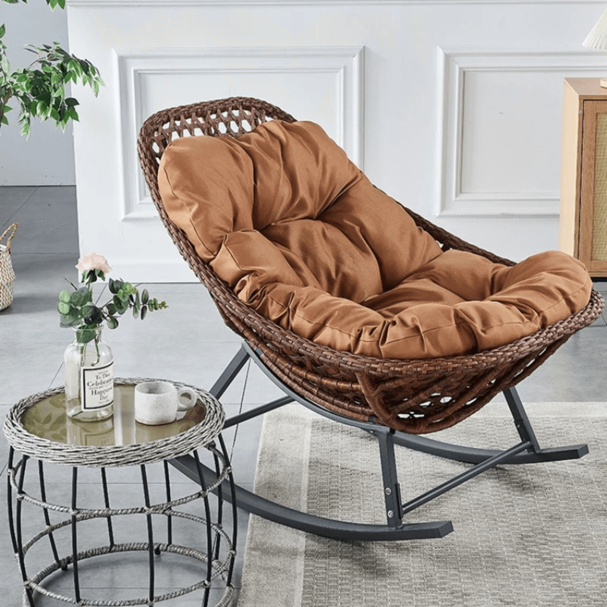 Side view of reclining rattan rocking chair with iron legs and soft cushion