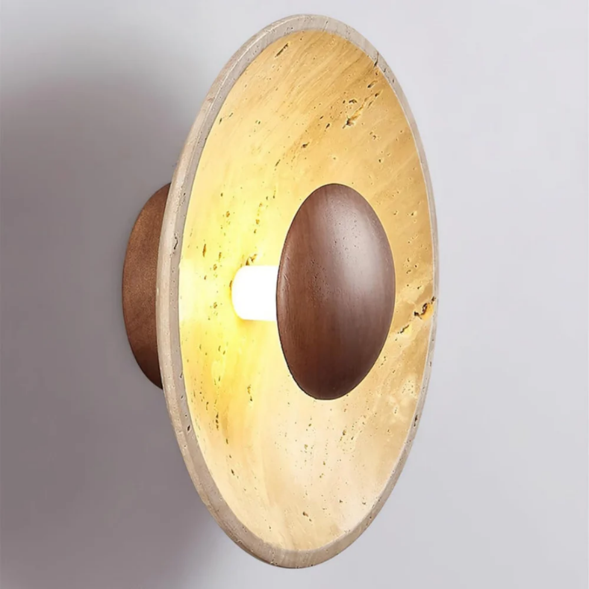 Side angled view of Solara Travertine Round Wall Light showing depth profile and hardwired LED fitting
