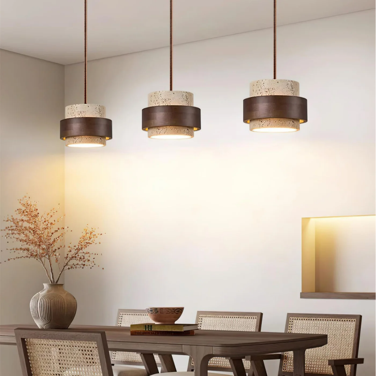 three TerraHalo pendants cascading above a dining table with vase and books