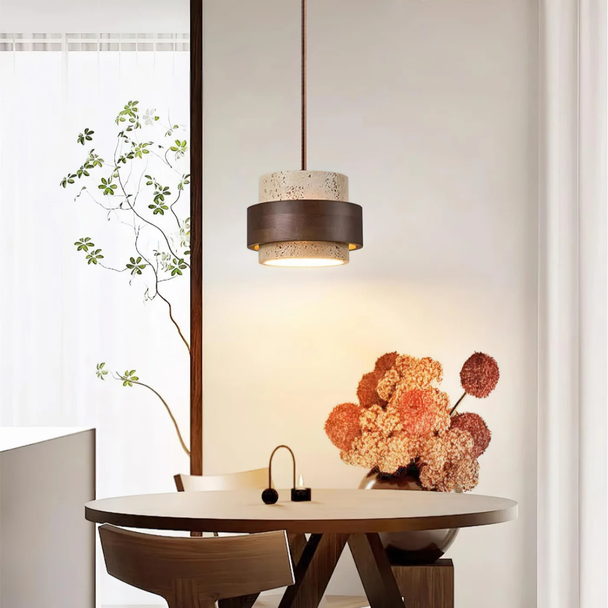 lifestyle dining area with TerraHalo pendant above table near dried flower arrangement