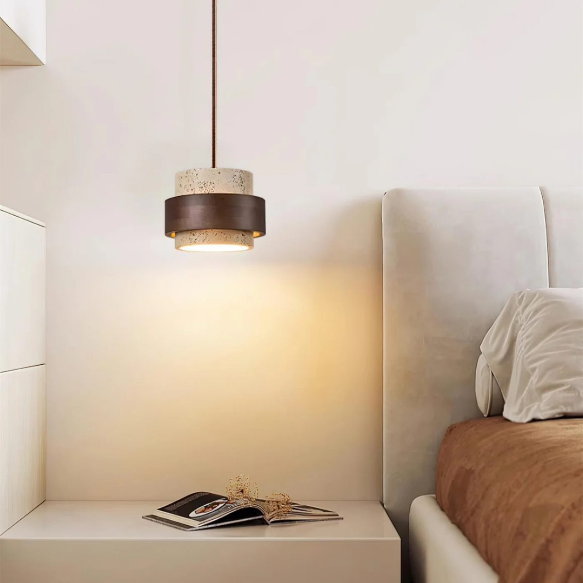 lifestyle bedside scene with pendant lit beside upholstered headboard