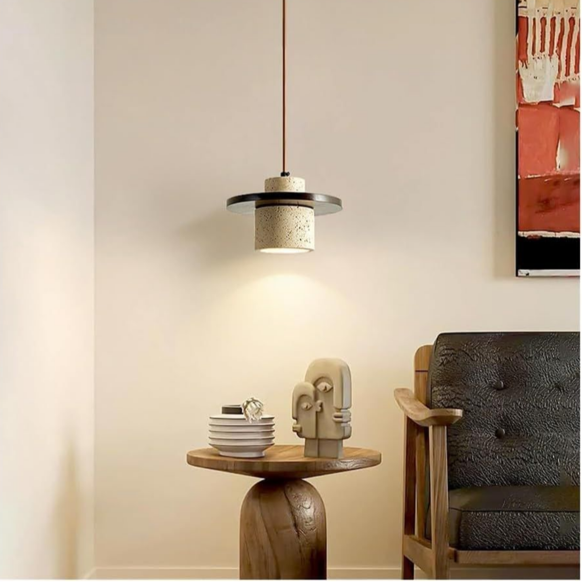 lifestyle above a wooden pedestal side table beside an abstract painting