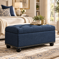 Wooden Twist navy blue tufted rectangle storage ottoman with nailhead trim – lifestyle view at the foot of a bed
