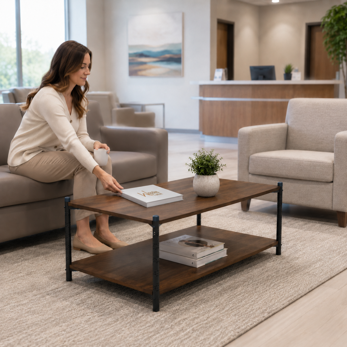 lifestyle office lounge, woman reaching for a book on the tabletop