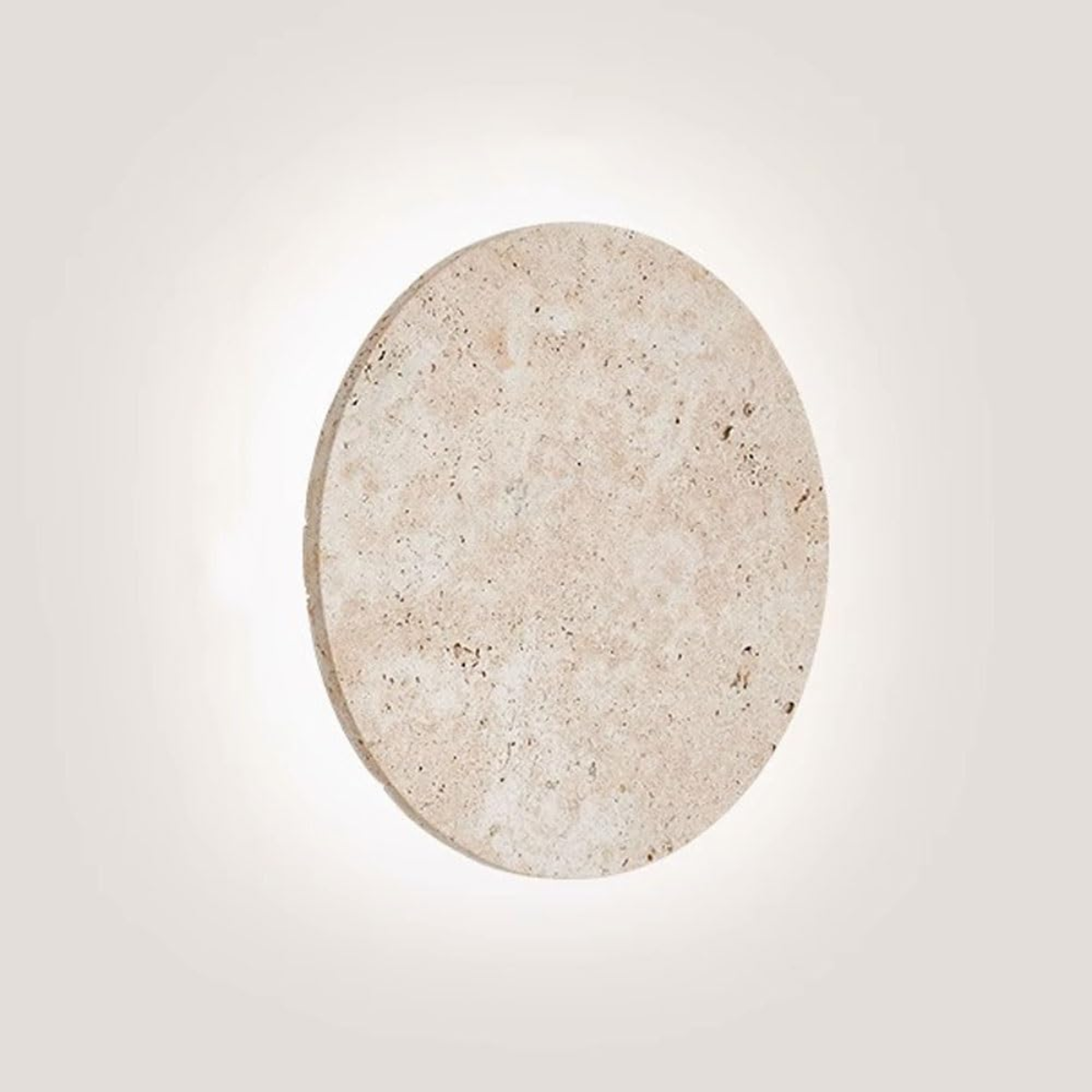 Lunaro Travertine Round Wall Sconce - front view lit with soft halo glow