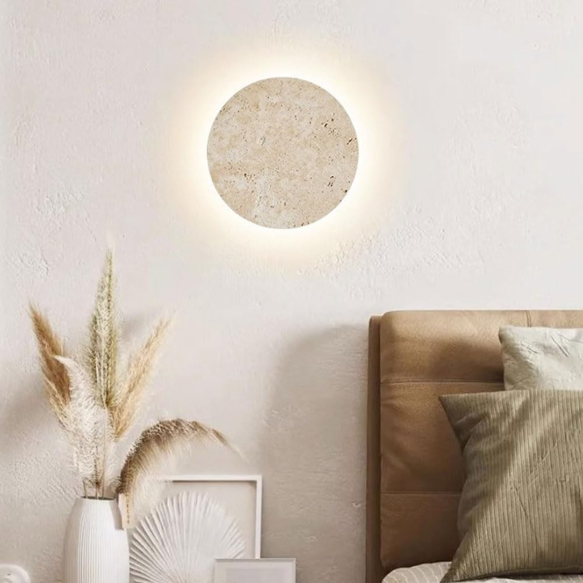 Lunaro Travertine Round Wall Sconce - lifestyle lit above a bedroom headboard