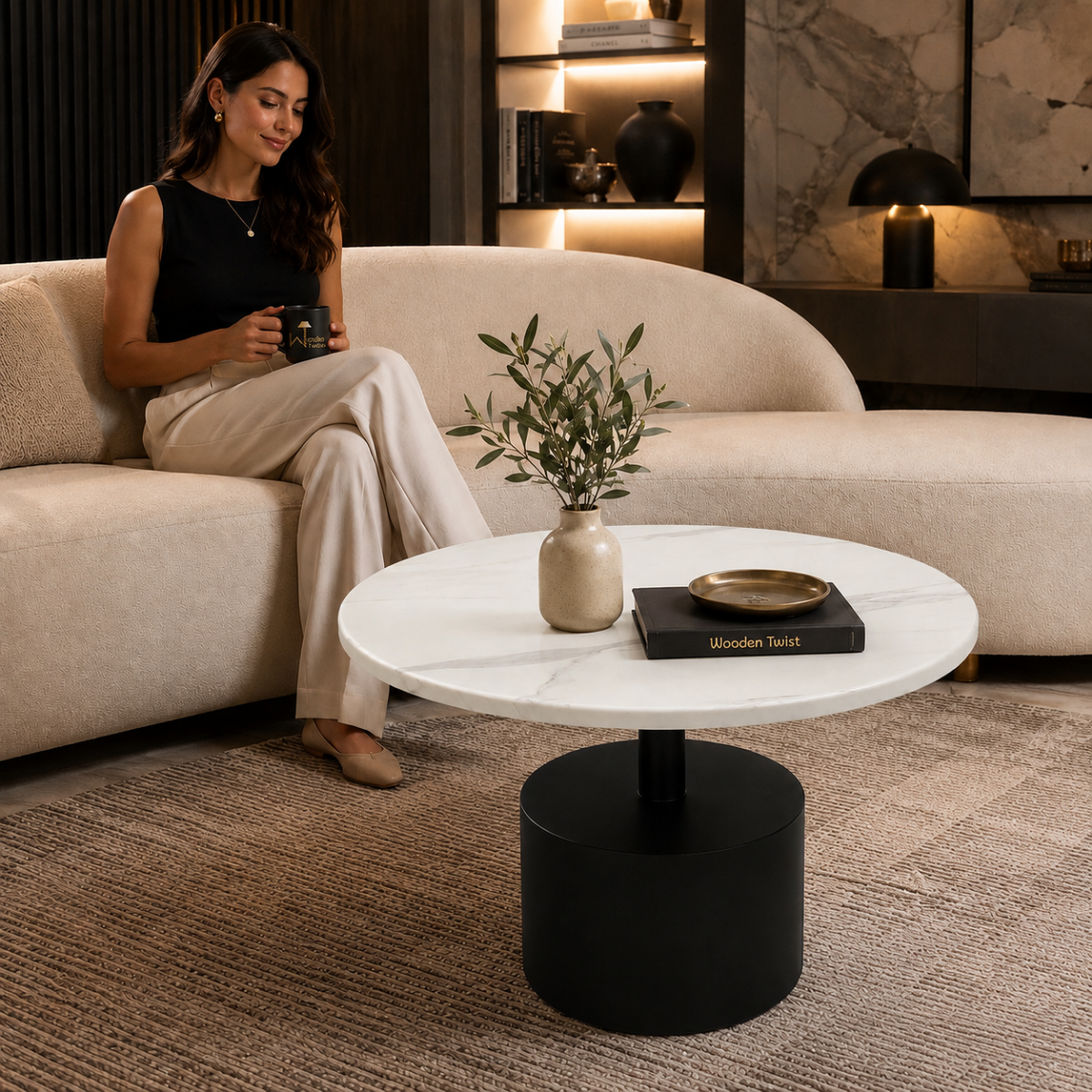 Wooden Twist Modern Round Sintered Stone Coffee Table 80cm, lifestyle view with model seated on sofa