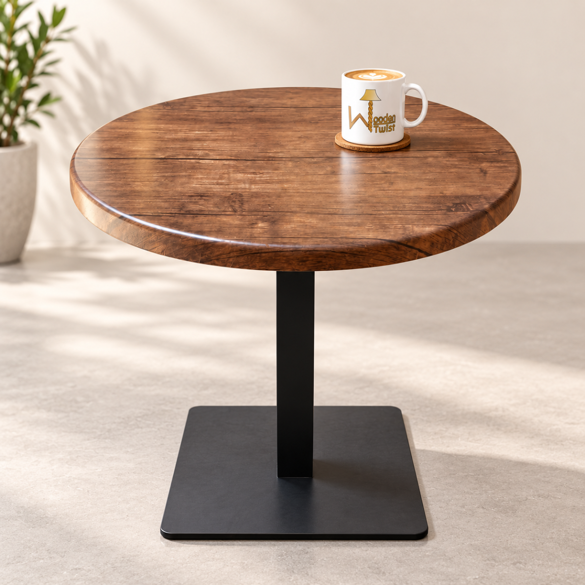 Rustica Round Dining Table - product shot with coffee mug and plant, plain background