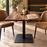 Rustica Square Dining Table - styled with candle, vase, salt and pepper grinders, cafe booth behind
