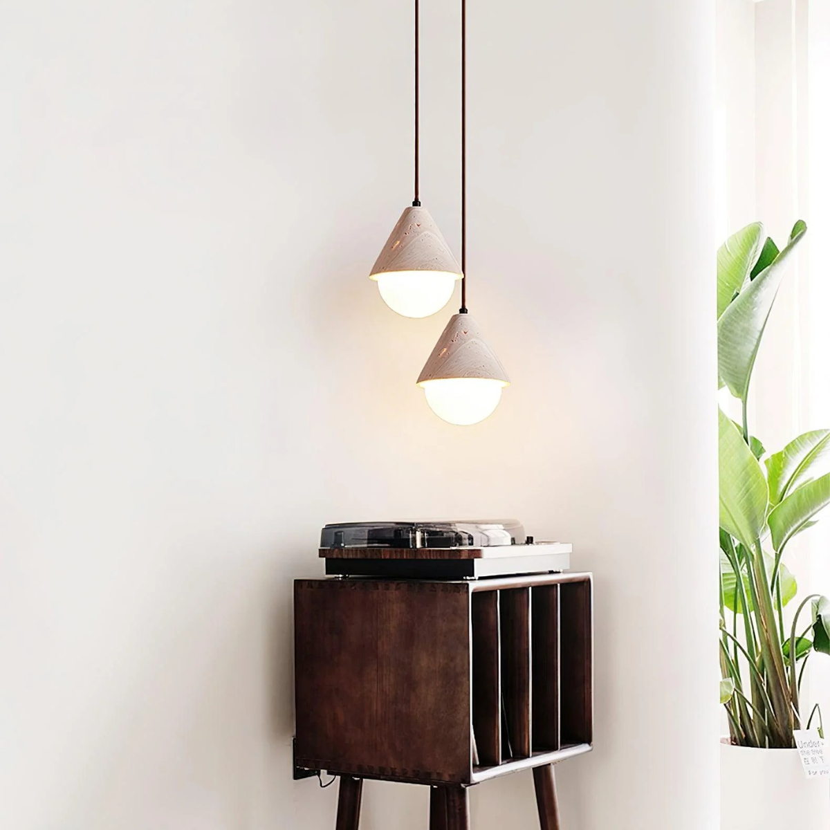 lifestyle two pendants above a wooden record cabinet