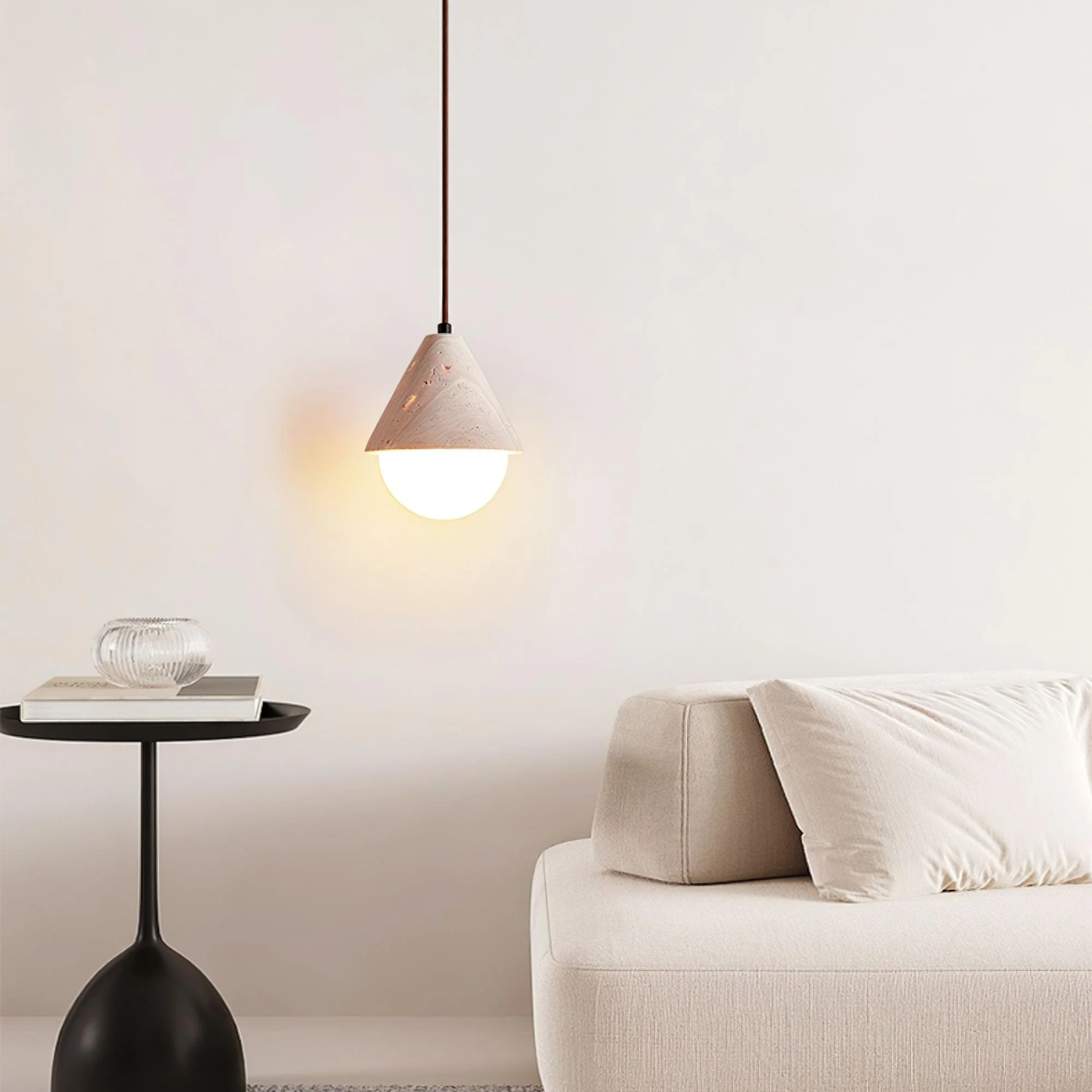 lifestyle above a black side table beside a cream sofa