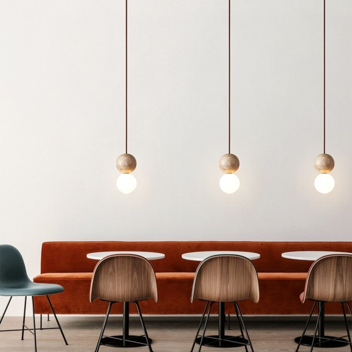 Mia Orb Pendant Light Natural - lifestyle three pendants above a cafe banquette seating