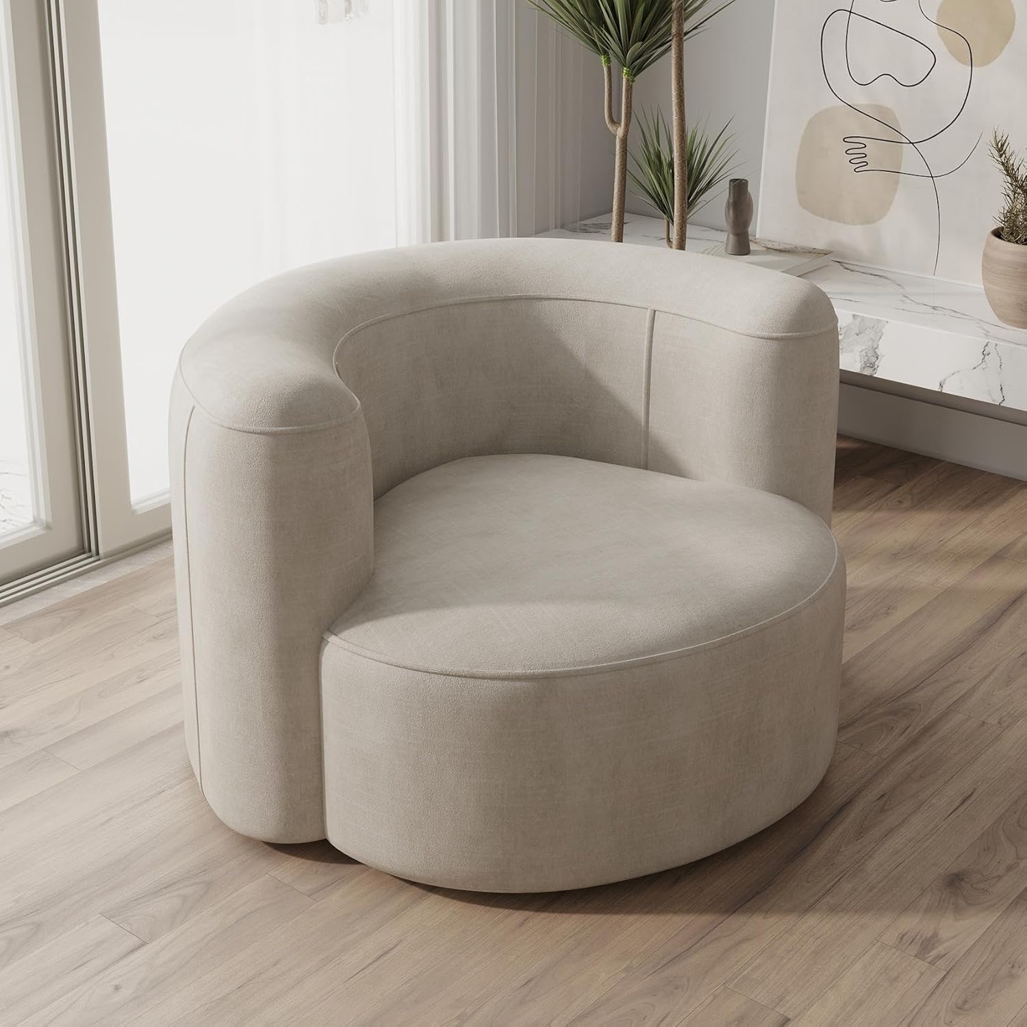 Beige armchair in a modern living room with a neutral color palette.