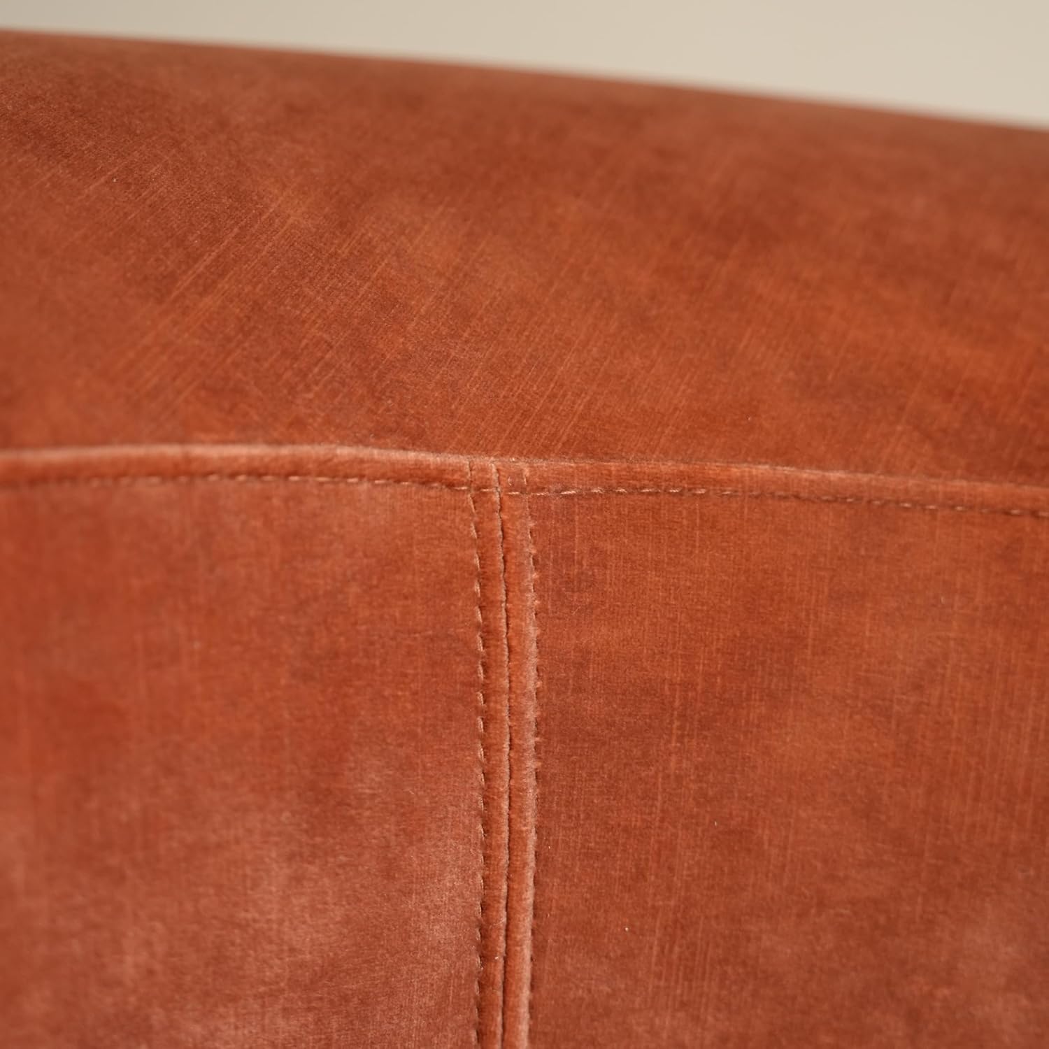 Close-up of a brown leather surface with visible stitching