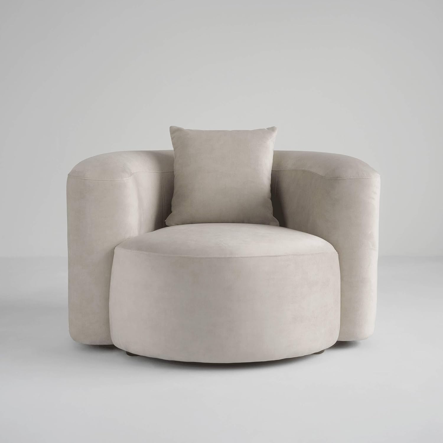 Beige armchair with a cushion on a light gray background