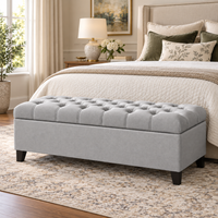 Wooden Twist Zelja velvet flip top storage bench in light gray – lifestyle view at the foot of a bed